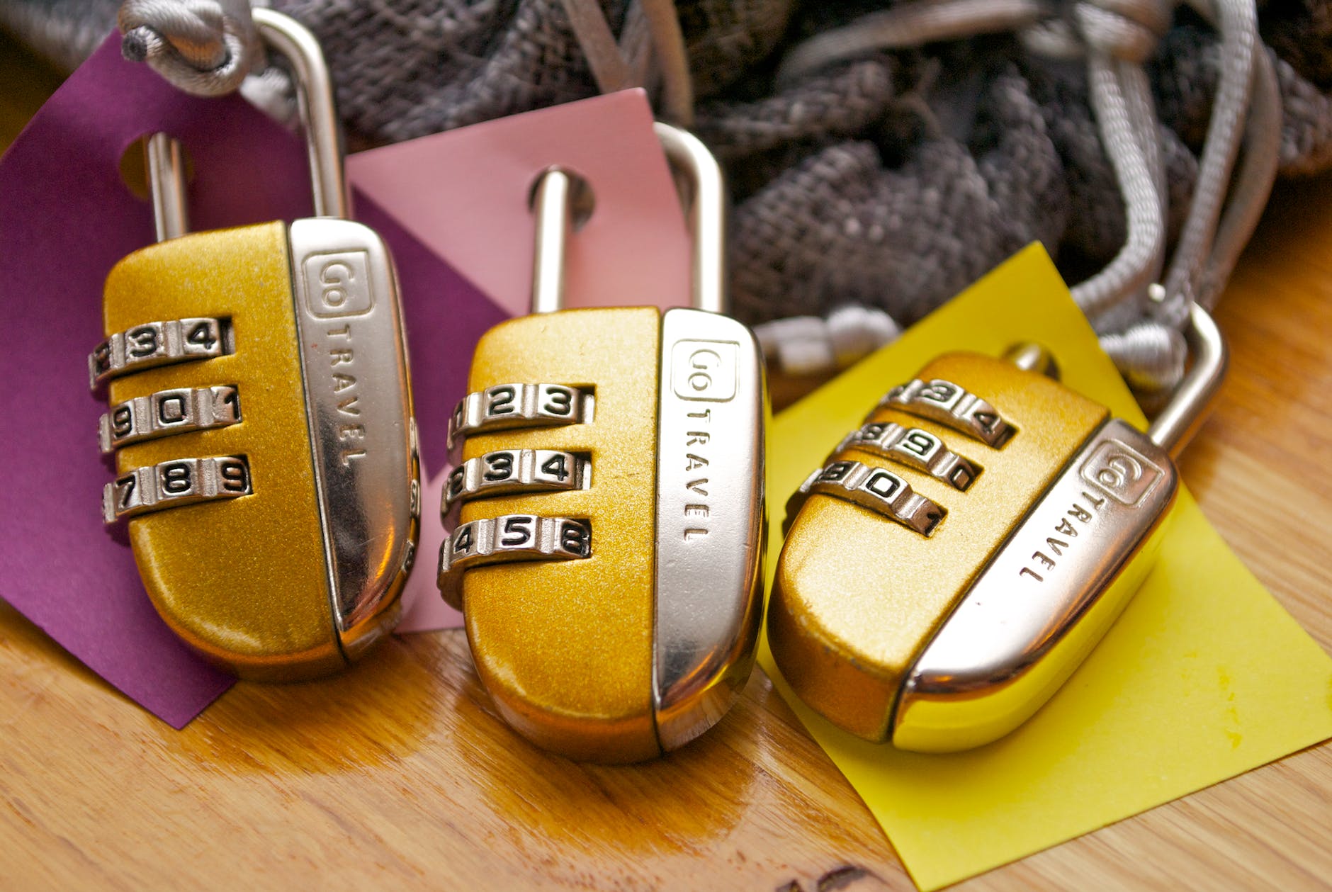 three gold and silver combination padlocks